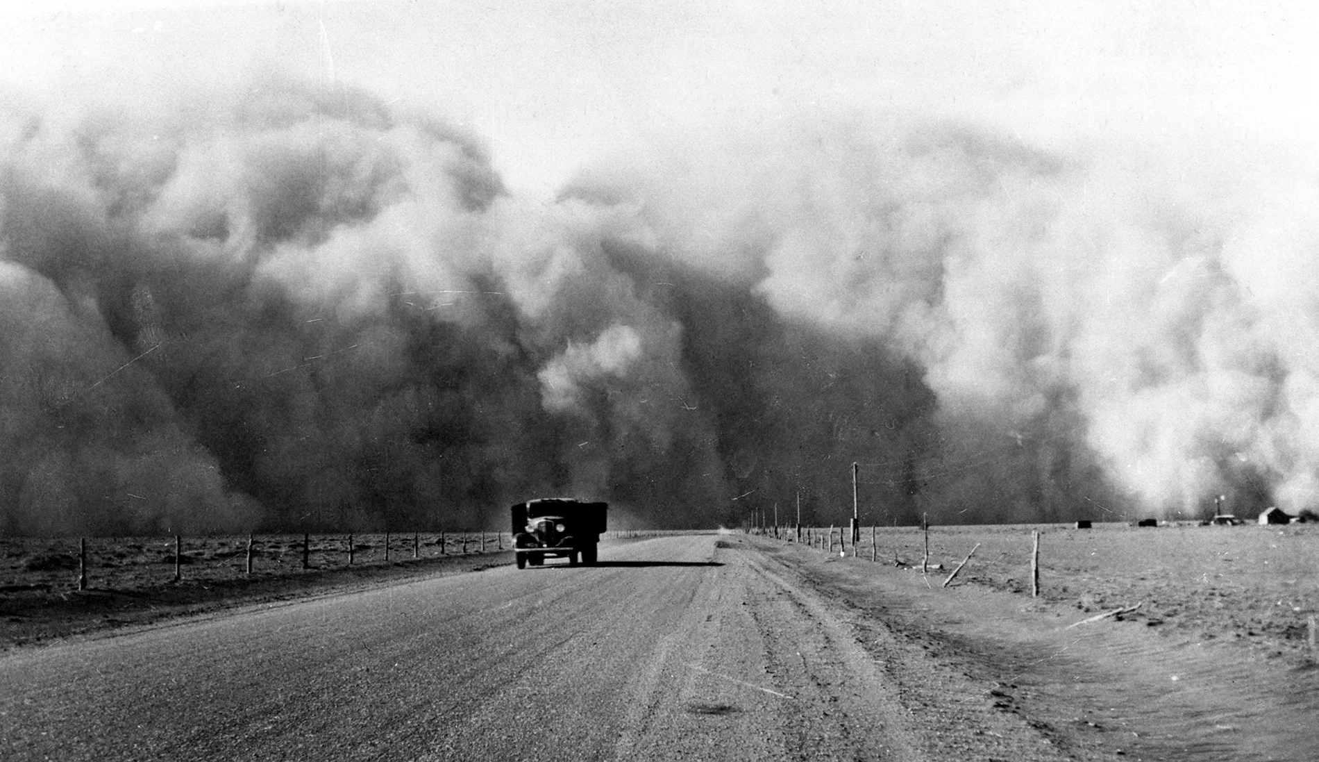 South of Lamar, Colorado, a large dust cloud appears behind a truck traveling on highway 59, May 1936