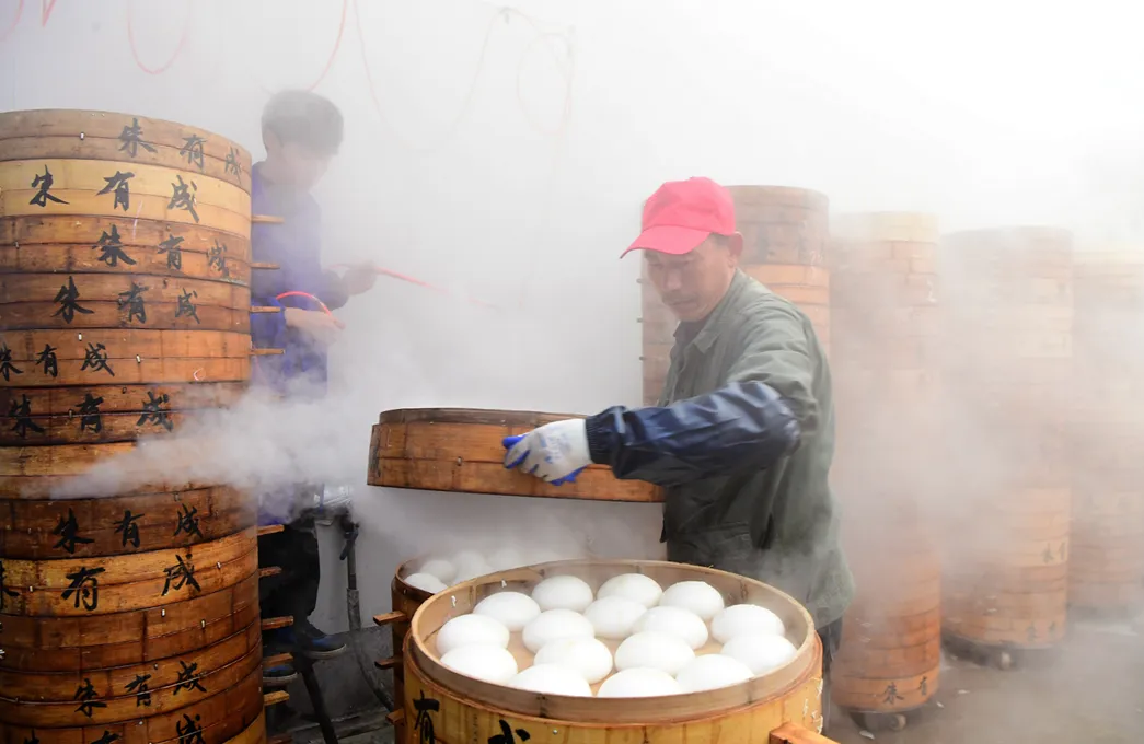 Employees make steamed buns (or Mantou) to ensure Spring Festival market supply on February 6, 2024 in Jinhua, Zhejiang Province of China. 