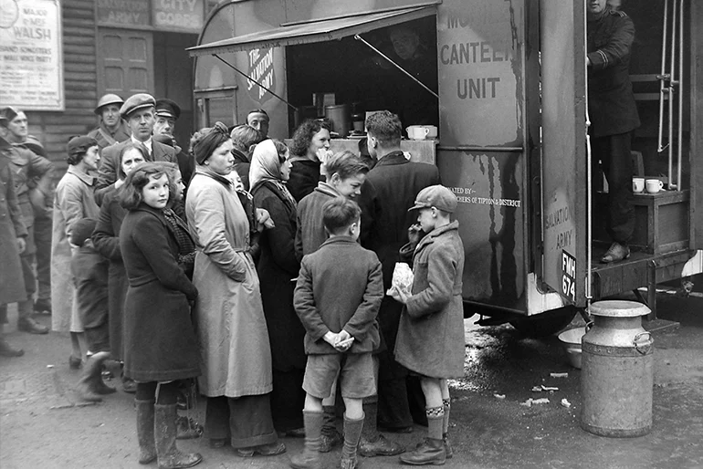 People gather around the Salvation Army in Coventry, UK during WWII. Food banks have long played an important role in supporting those in need. (Coventry Telegraph Archive/Getty Images)
