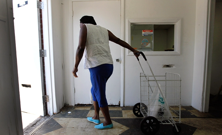 Pauline McKinney leaves the charity food bank in her Miami neighbourhood.