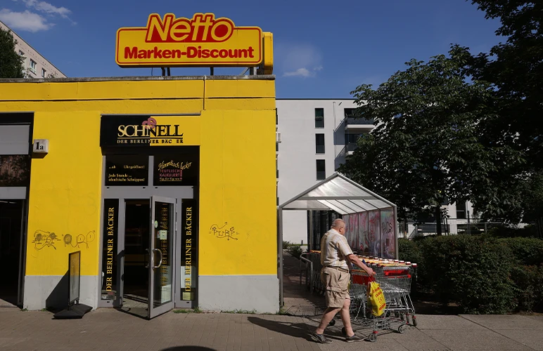 A man leaving a discount grocery market in Berlin, Germany