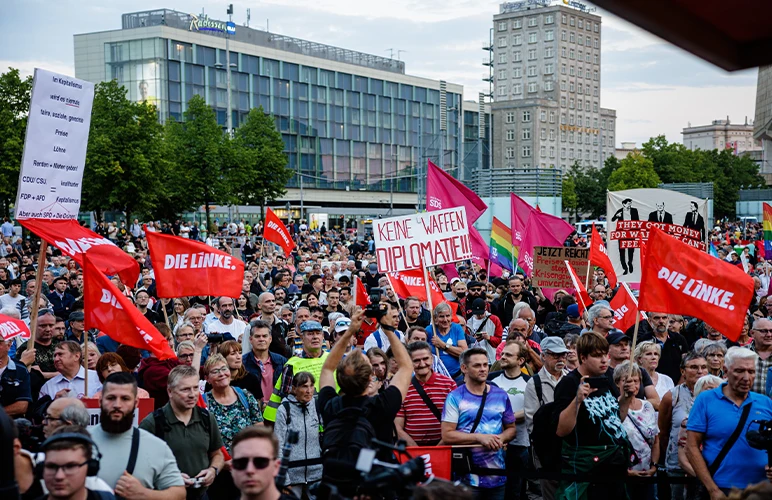 Protesters carrying banners and flags demanding action against the high food and energy prices in Leipzig, Germany