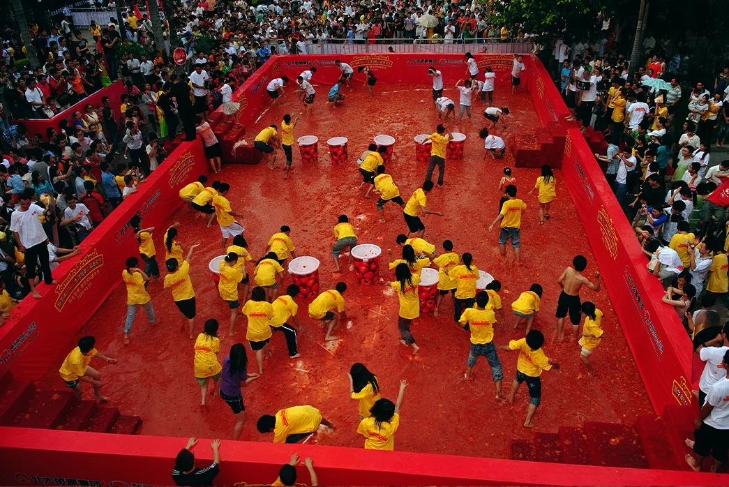 Contestants of teams fight during the ‘tomato war’ in Wanjiang Township, China